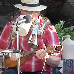Slim Harrison plays a mandolin and a one-man-band something-or-other