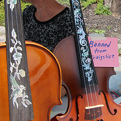 A fiddle for sale, with a note that says Banned from Craigslist