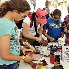 Several young adults make toy drums