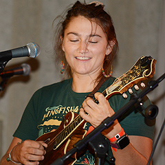 A woman mlays a mandolin on stage