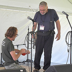 Two men prepare the stage for performers