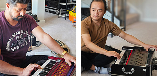 Two men playing harmonium: Apprentice Bhagirath Khatiwada (left) and Master Muskan Balampaki Mugar