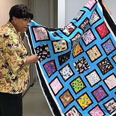 Narda LeCadre shows a quilt she made