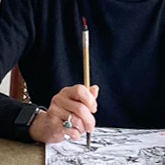 A close-up of Diana’s hand holding a brush.
