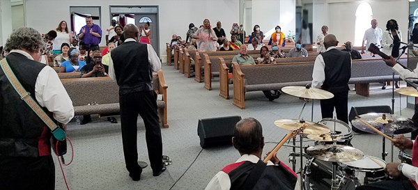 The Spiritual Messengers Warriors for God perform in a church.