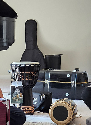 Several instruments in Muskan’s music room: a couple of Nepali drums, a guitar in its case, a grand piano.