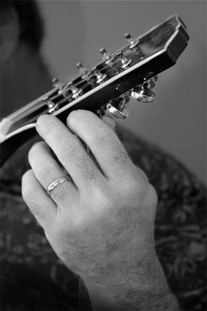 Tuning up! Closeup of a man's hand tuning a mandolin