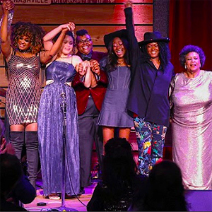 Curtain call at a Black Opry show, with several Black artists (mostly women) celebrating.