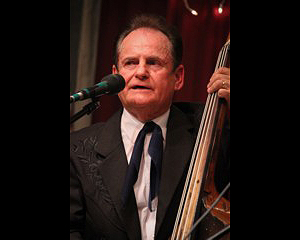 Jerry McCoury playing upright bass, wearing a tux, as a younger man
